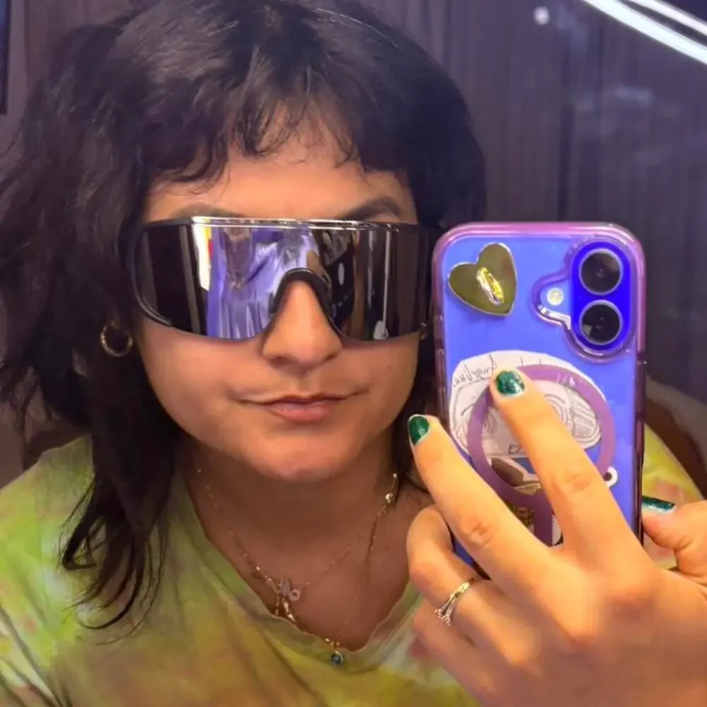 Unisex Black mirrored shield sunglasses with a sleek futuristic wraparound fit